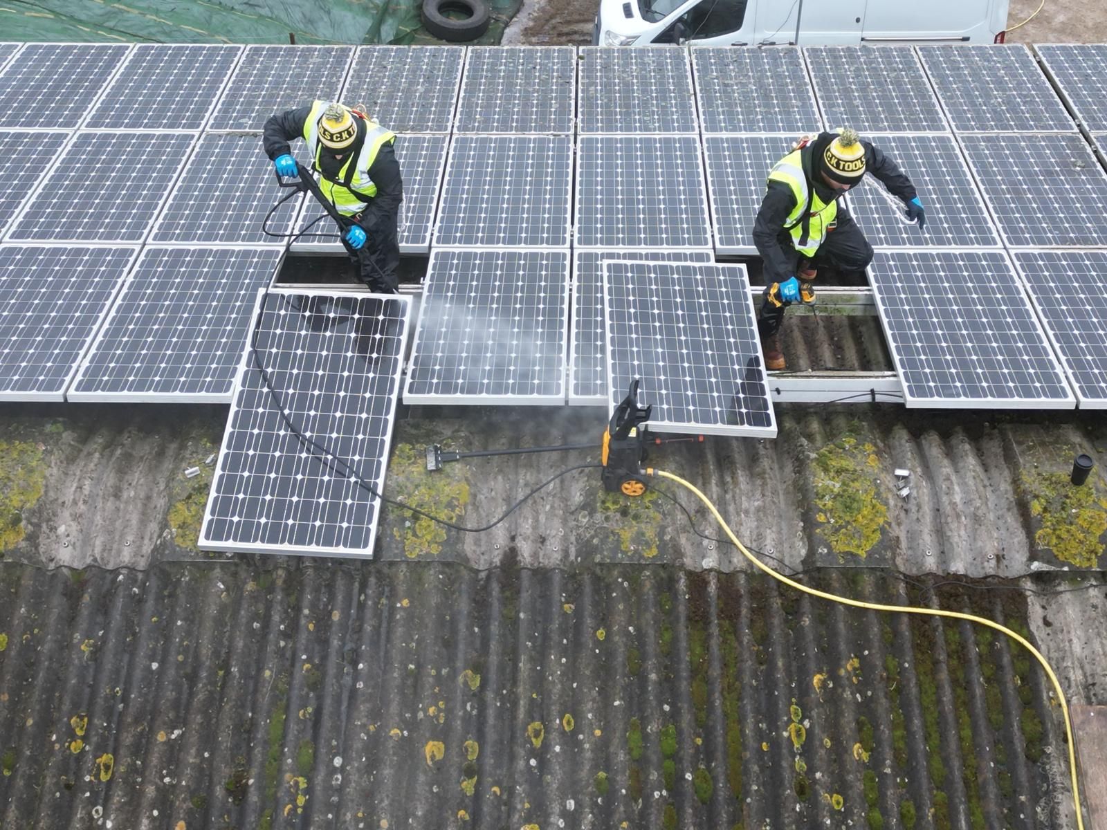 Installers working on an older solar panel system