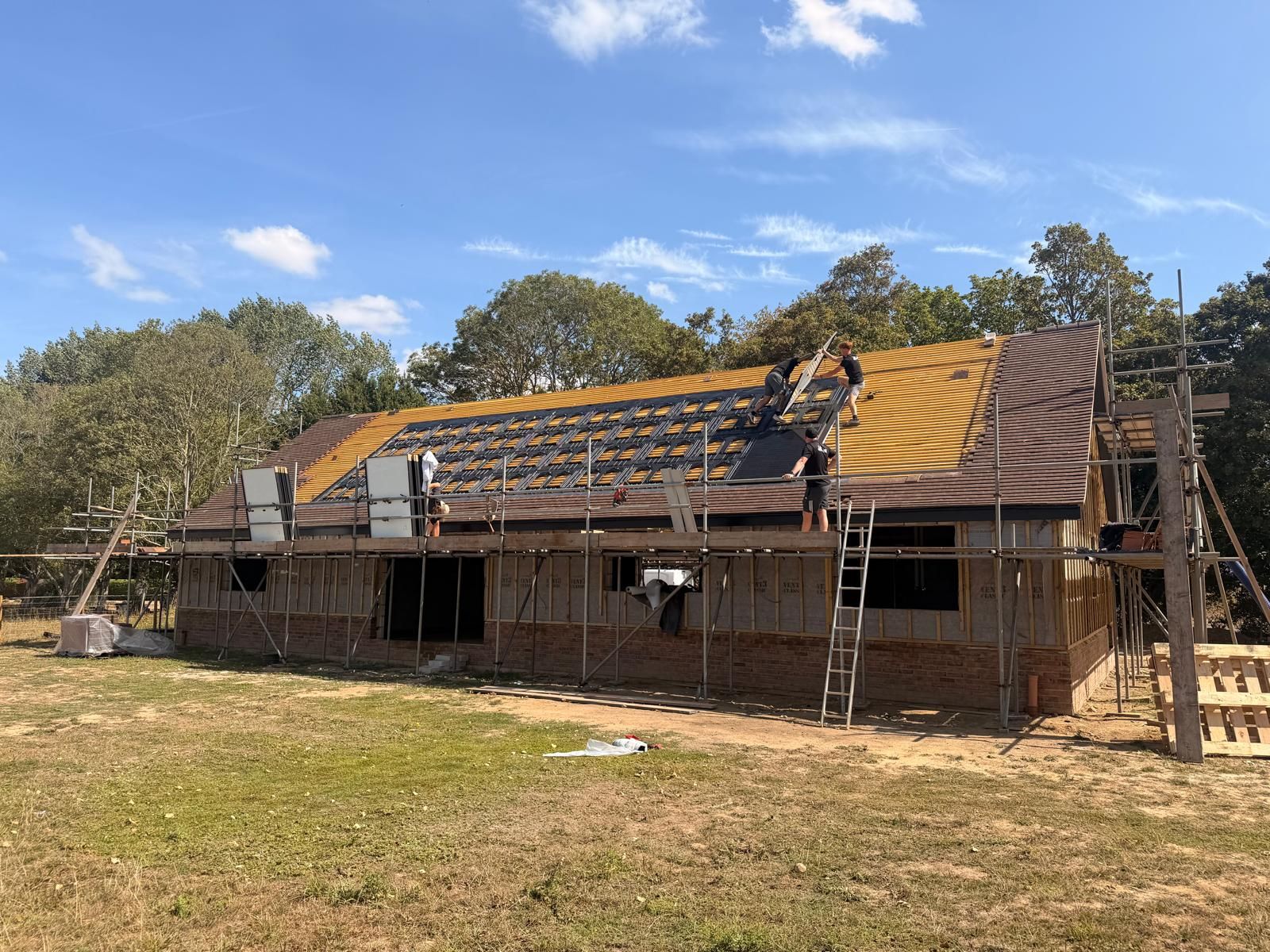 GS Solar team fitting in-roof solar panels on a new build