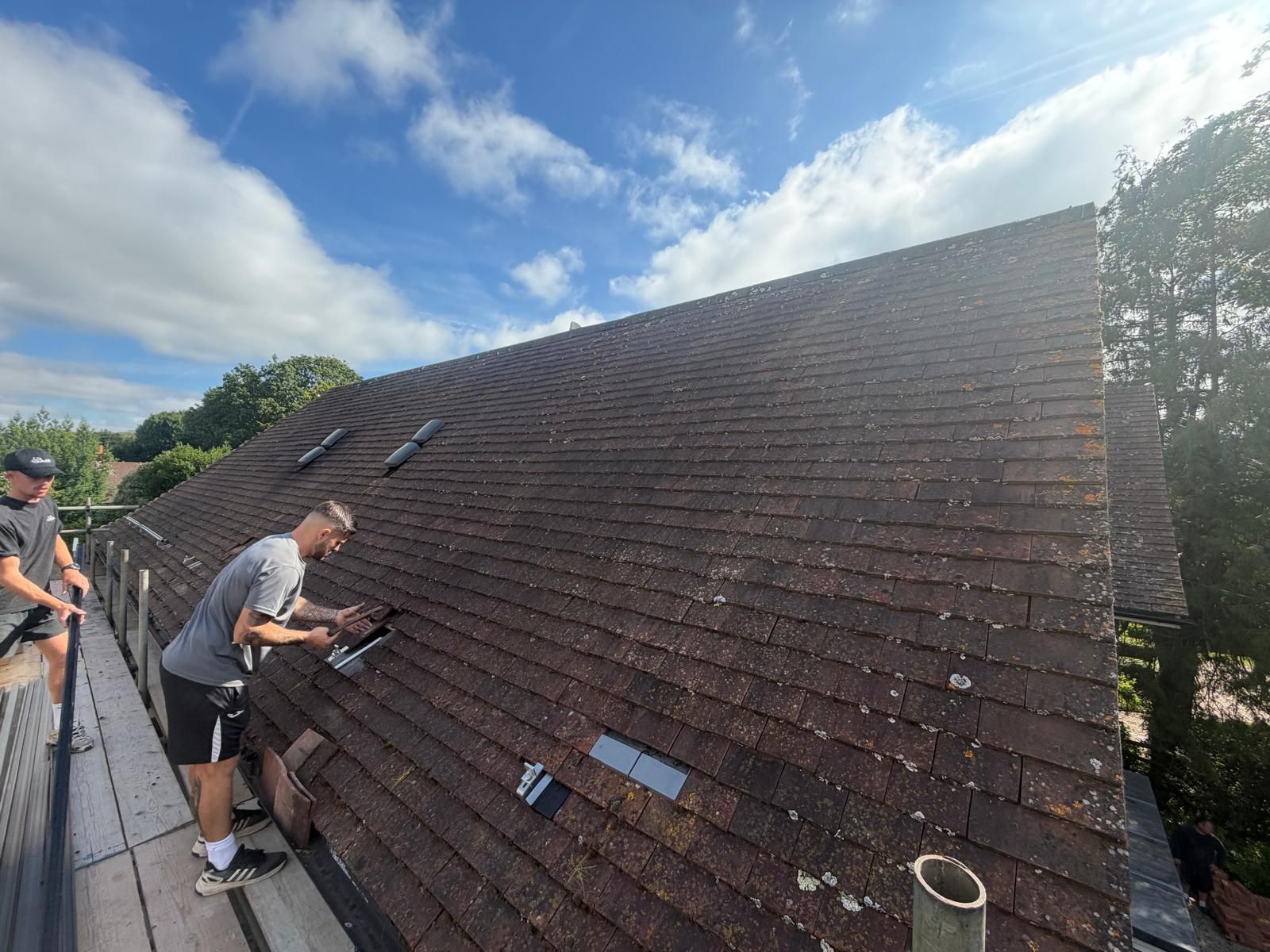 Installer preparing a tiled roof before solar installation