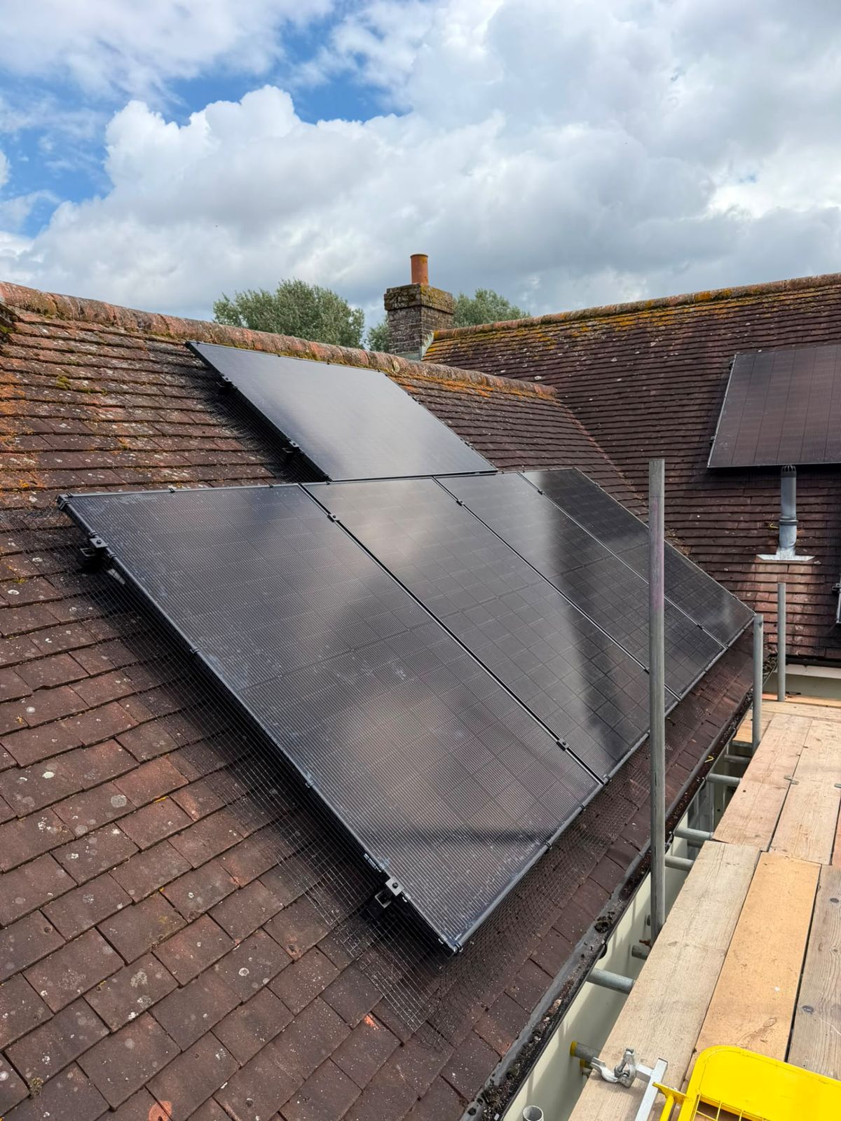 Solar panels installed on an older clay tile roof
