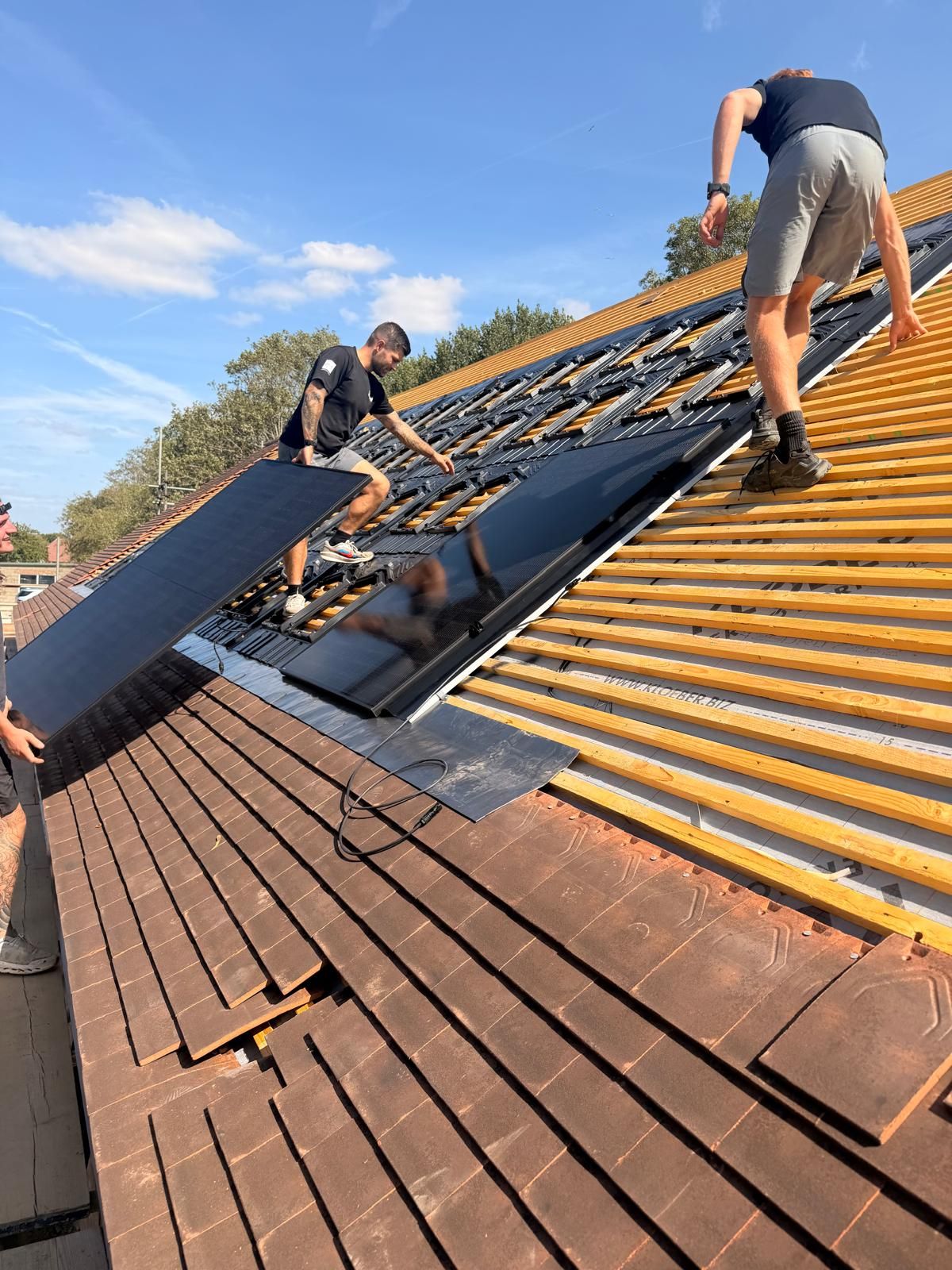 GS Solar installers fitting panels on a roof